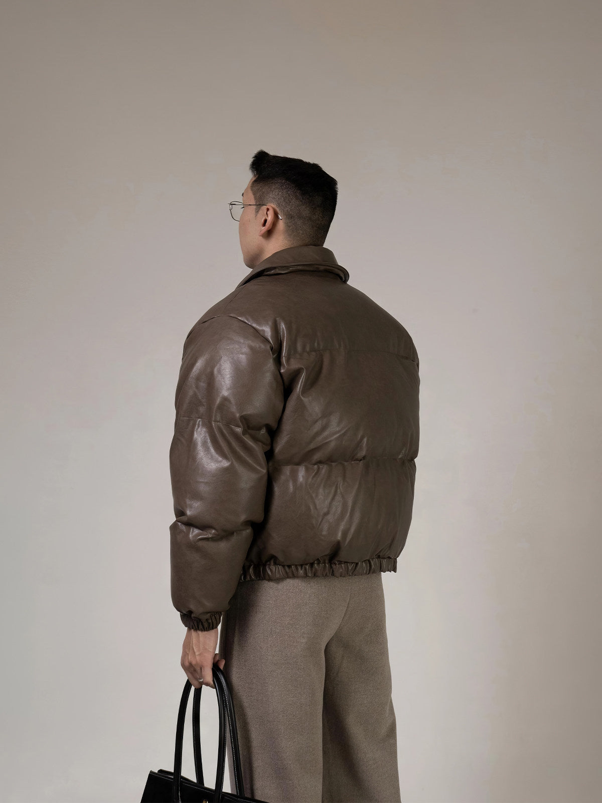 PU Leather Puffer Jacket With A Stand-up Collar And Extra Padding